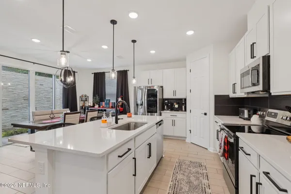 a kitchen with stainless steel appliances a sink stove and cabinets