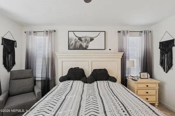 a bedroom with a bed a couch and dresser