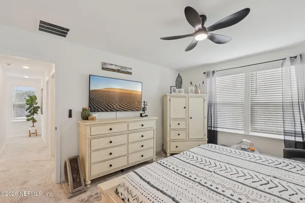 a bedroom with a bed and a television