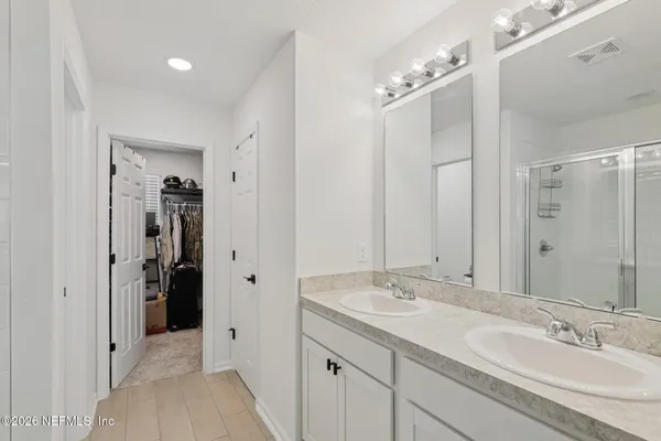 a bathroom with a granite countertop sink mirror and double