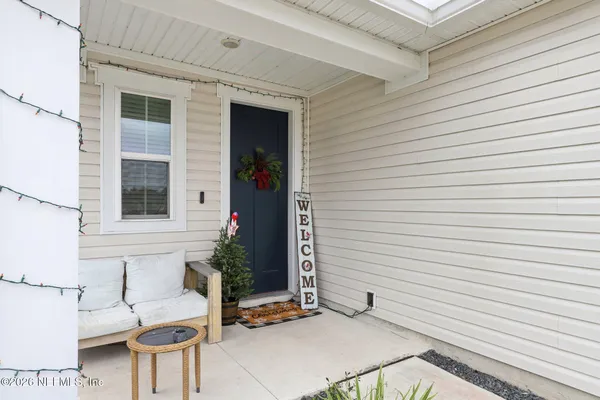 a view of a patio with table and chairs and potted plants