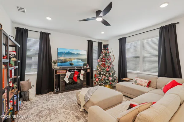 a living room with furniture and a flat screen tv