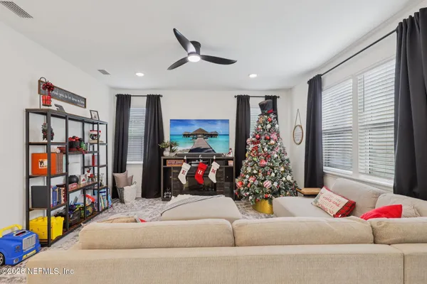 a living room with lots of furniture and a large window