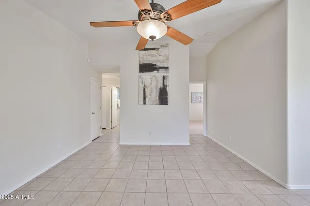 wooden floor in an empty room and a chandelier fan