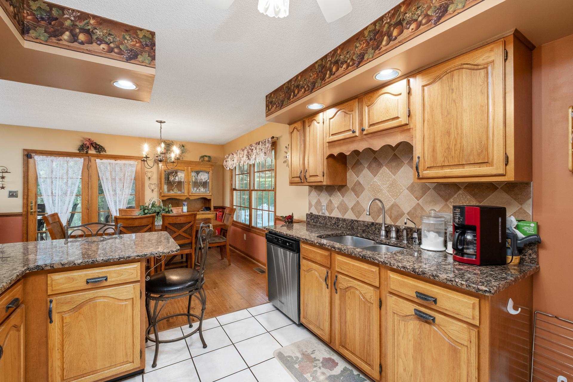 556 Buttermilk Spring Road Staunton, VA 24401 - Photo 20 of 67 a kitchen with stainless steel appliances granite countertop a sink and cabinets