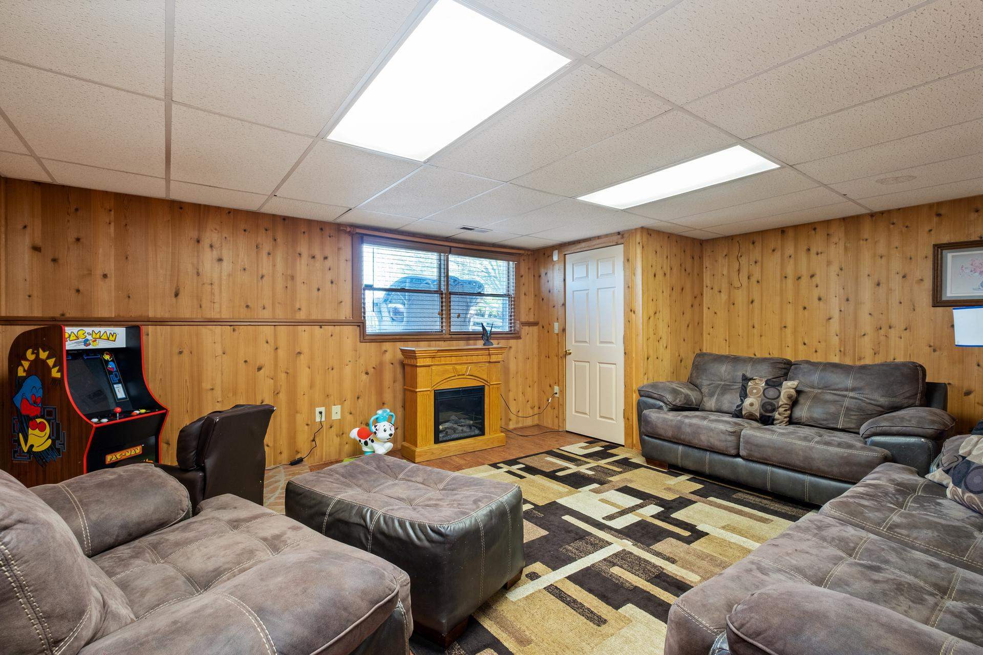 556 Buttermilk Spring Road Staunton, VA 24401 - Photo 32 of 67 a living room with furniture a fireplace and a flat screen tv