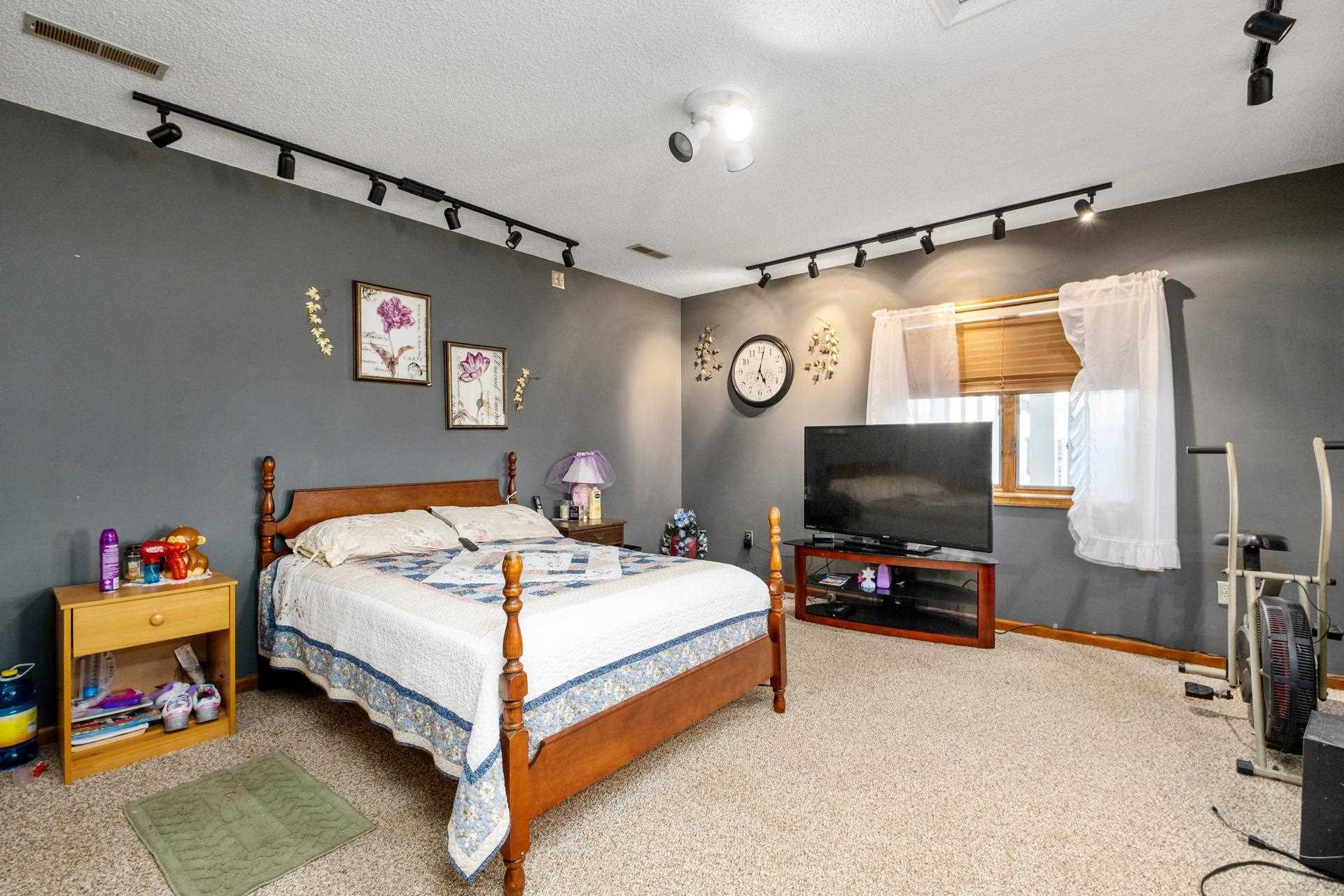 556 Buttermilk Spring Road Staunton, VA 24401 - Photo 45 of 67 a bedroom with a bed and a flat tv screen on the dresser