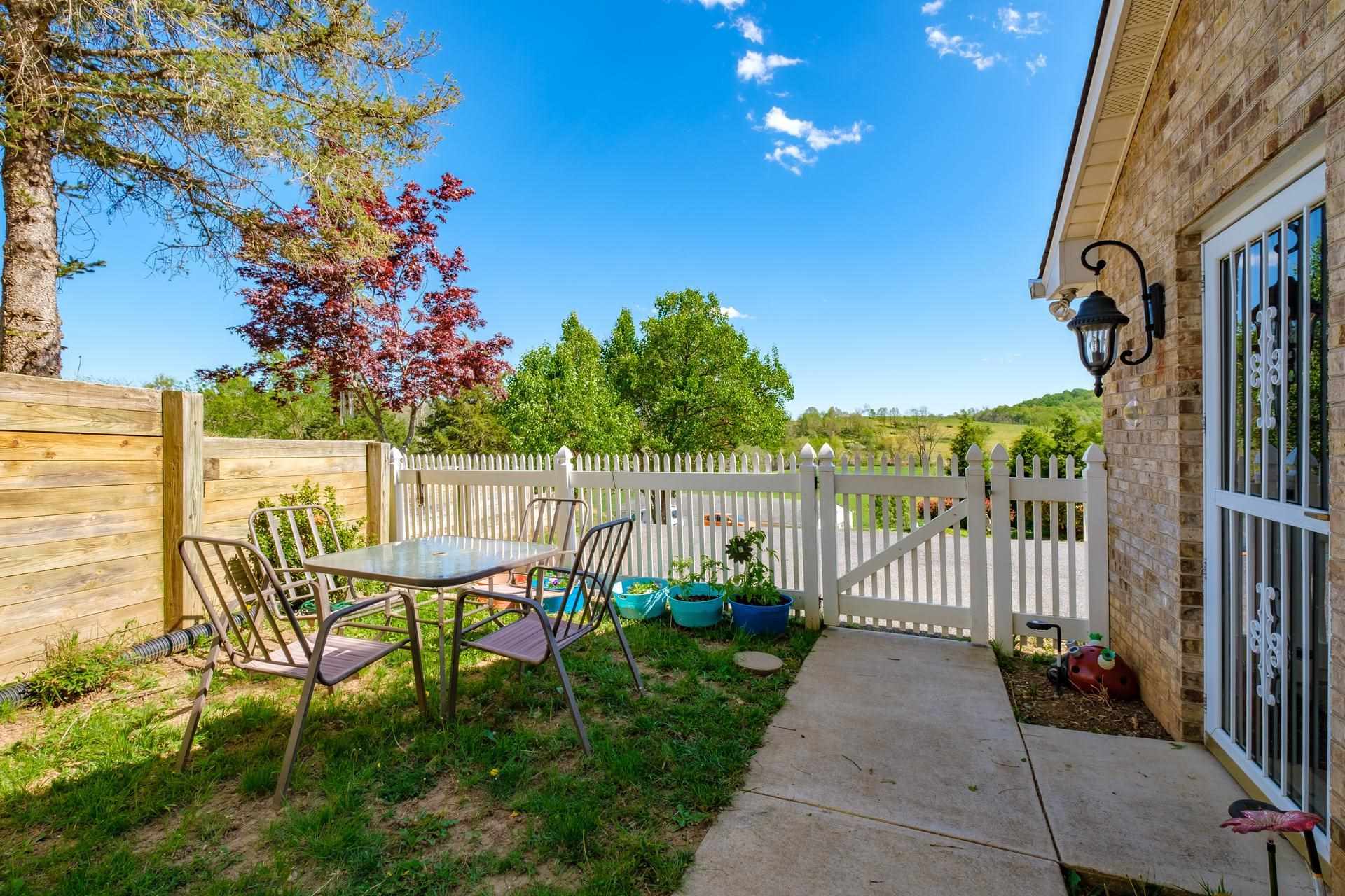 556 Buttermilk Spring Road Staunton, VA 24401 - Photo 52 of 67 a view of a chairs and table in patio with wooden fence