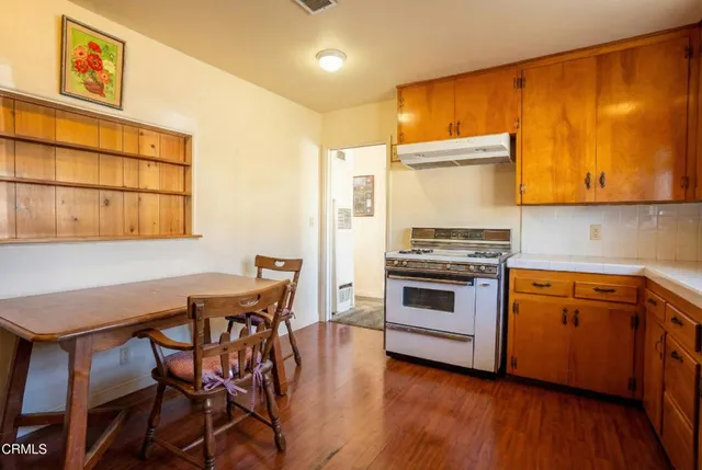 a kitchen with stainless steel appliances a stove a sink dishwasher and cabinets