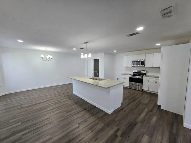 a view of kitchen with refrigerator stove and oven