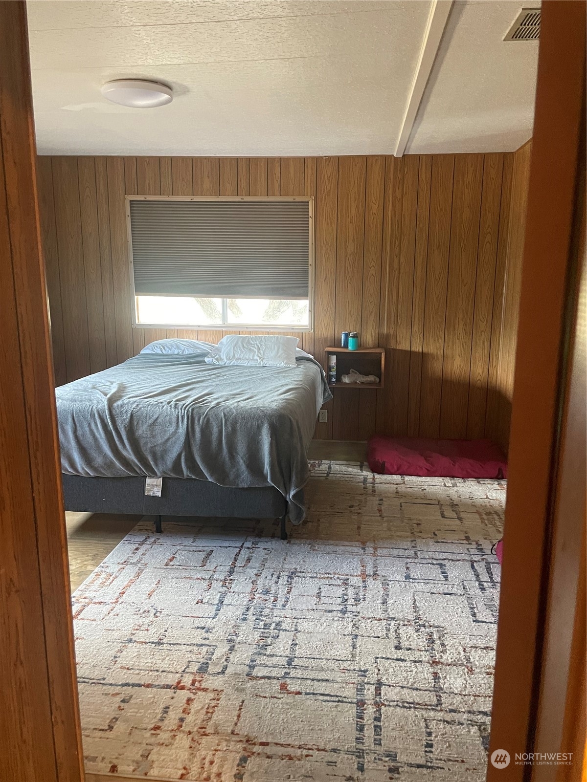 76398 East Highway 730 Irrigon, OR 97844 - Photo 6 of 17 a bed sitting in a bedroom next to a window and a wooden door