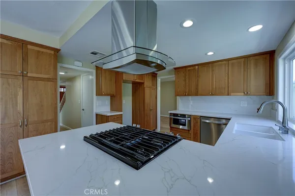 a kitchen with stainless steel appliances a refrigerator and a sink