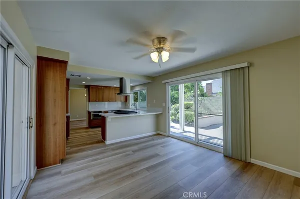 a view of a hallway with wooden floor and a living room