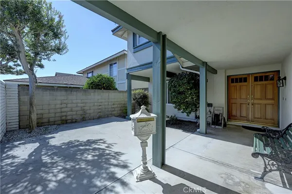 an empty room with wooden floor a fireplace and windows