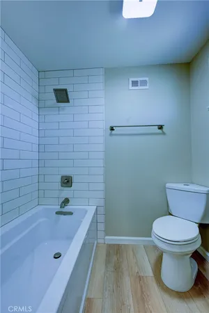 an empty room with wooden floor and chandelier fan