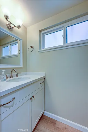 a kitchen with wooden cabinets a sink and a stove