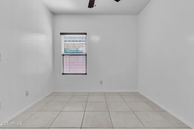 a view of a livingroom with an empty space and a window