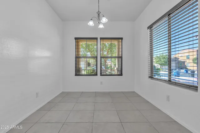 a view of a livingroom and a chandelier fan
