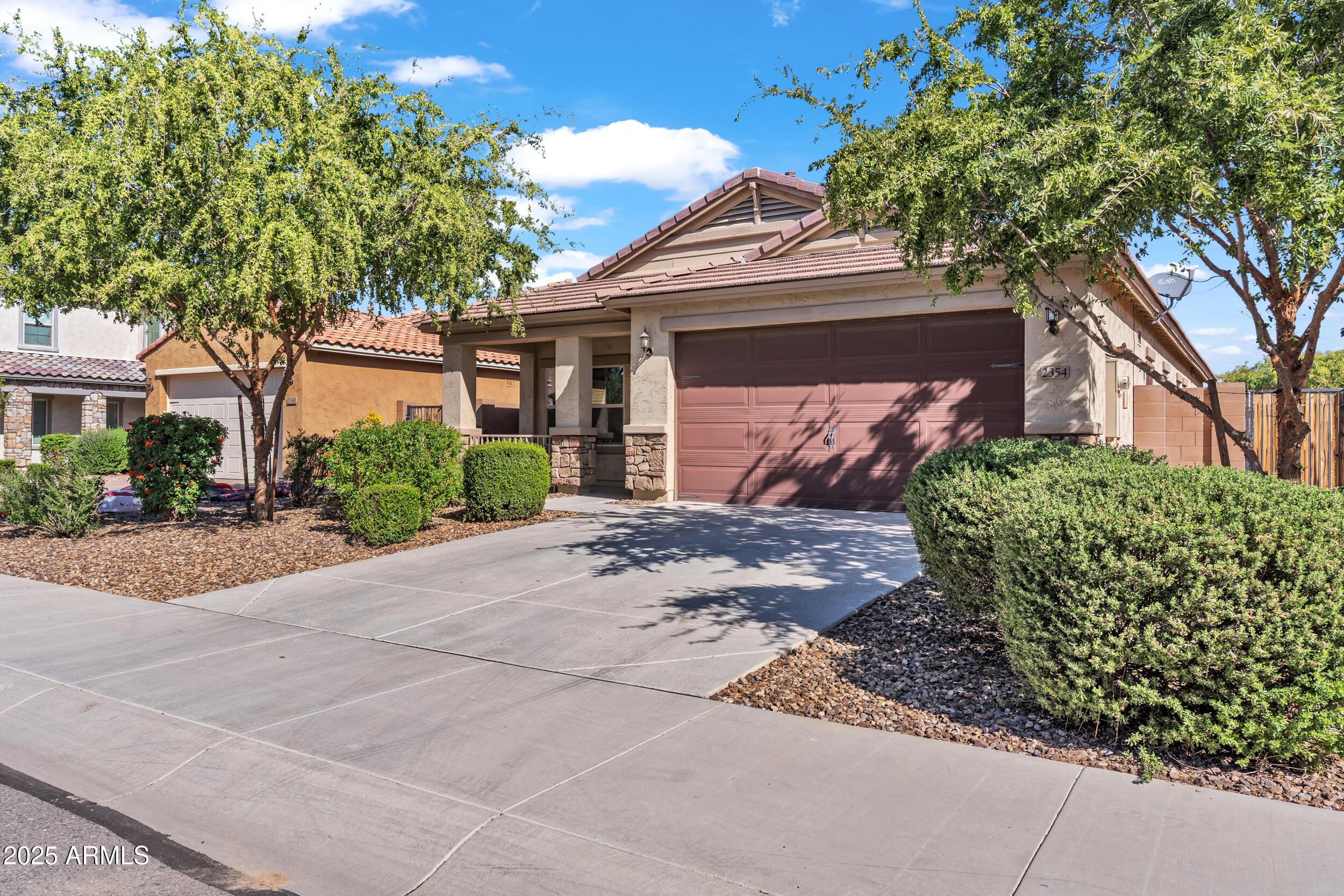 2354 East Bellerive Drive Gilbert, AZ 85298 - Photo 2 of 34 a front view of a house with a yard and a garage