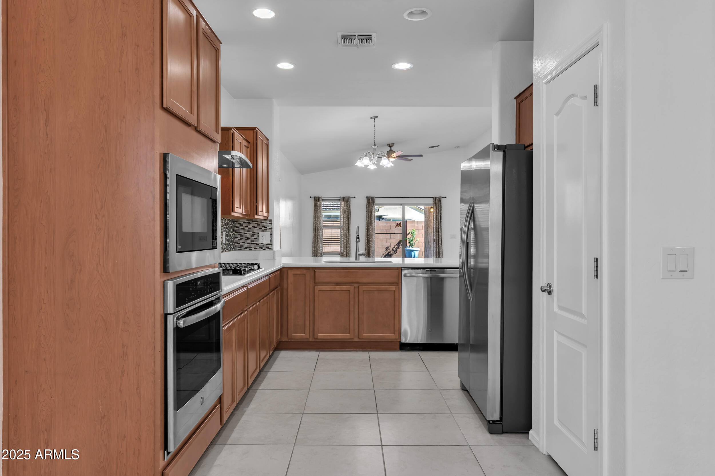 2354 East Bellerive Drive Gilbert, AZ 85298 - Photo 8 of 34 a kitchen with a refrigerator and a sink
