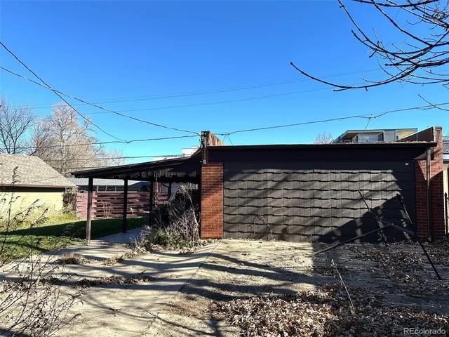 a view of a house with a small yard and wooden fence