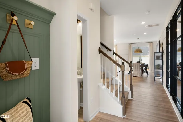a hallway with a wooden floor and stairs