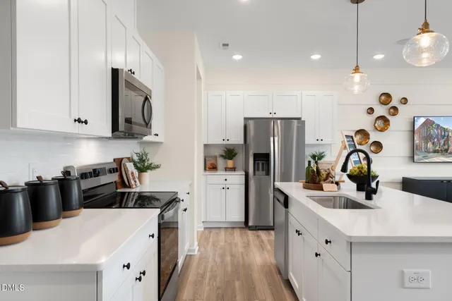 a kitchen with a sink a stove and refrigerator