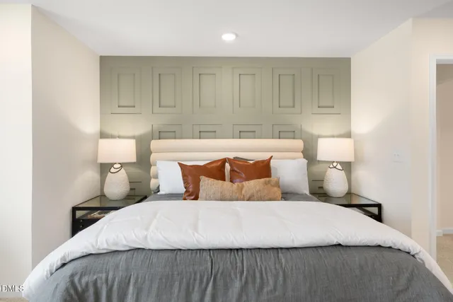 a bedroom with a bed and a night stand