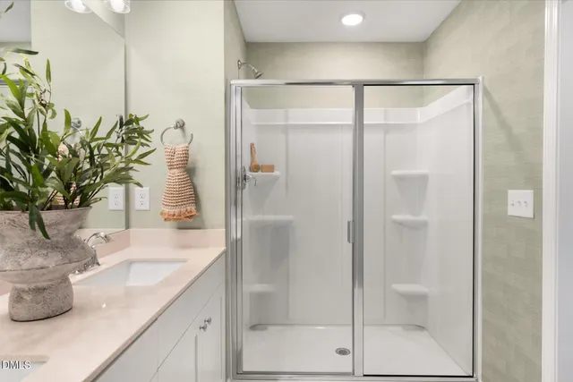a bathroom with a shower and a sink