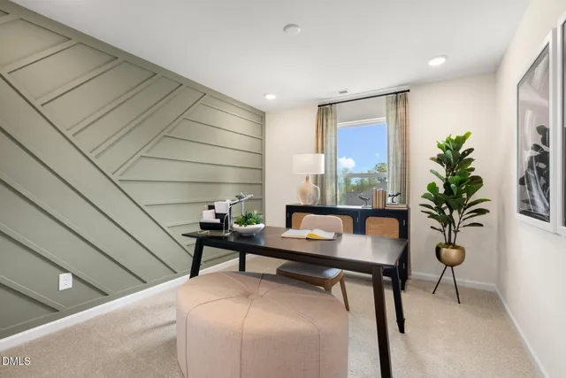 a reading room with furniture and a potted plant