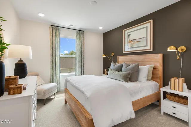 a bedroom with a large bed and a window