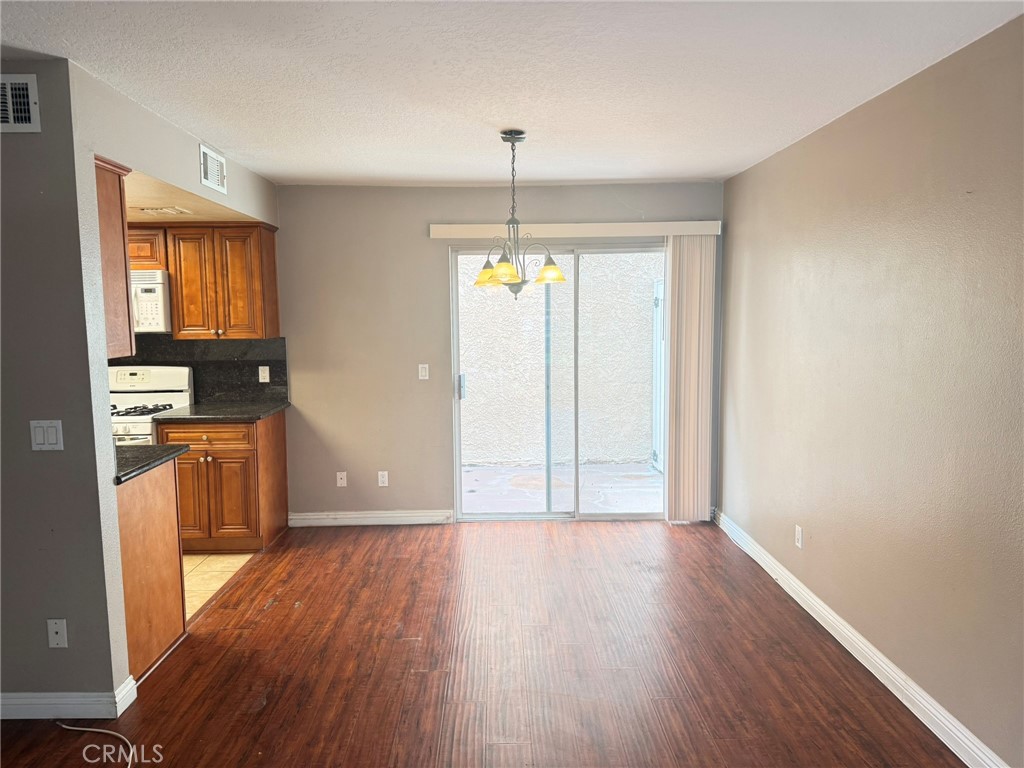 77 North Michigan Avenue, Unit 3 Pasadena, CA 91106 - Photo 6 of 11 a view of an empty room with window and wooden floor