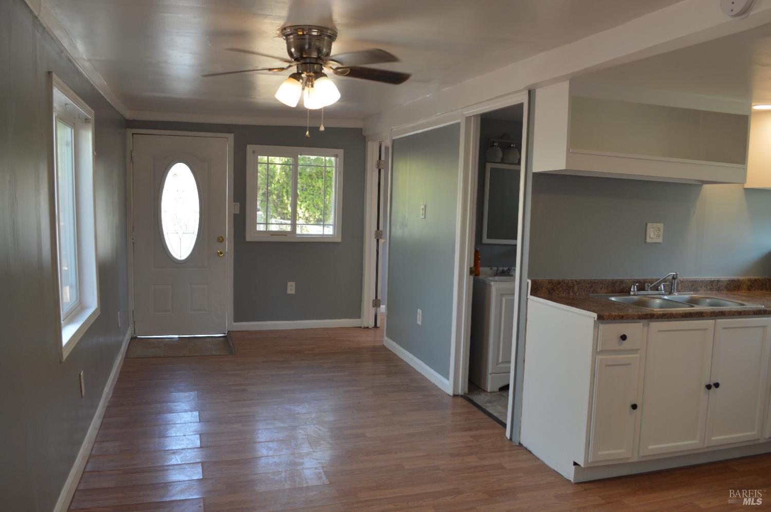 3525 Madrone Street Clearlake, CA 95422 - Photo 4 of 13 a view of a kitchen with wooden floor and a ceiling fan