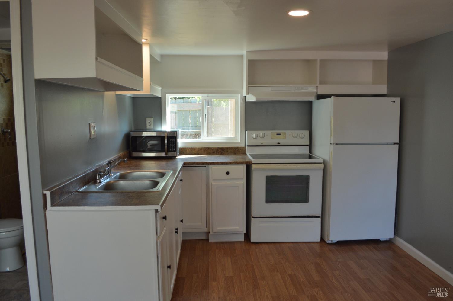 3525 Madrone Street Clearlake, CA 95422 - Photo 5 of 13 a kitchen with a stove sink and a refrigerator
