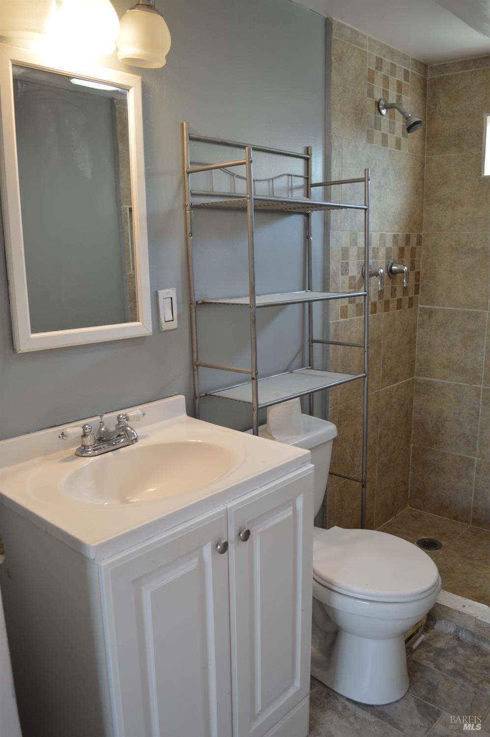 3525 Madrone Street Clearlake, CA 95422 - Photo 7 of 13 a bathroom with a sink toilet vanity and shower
