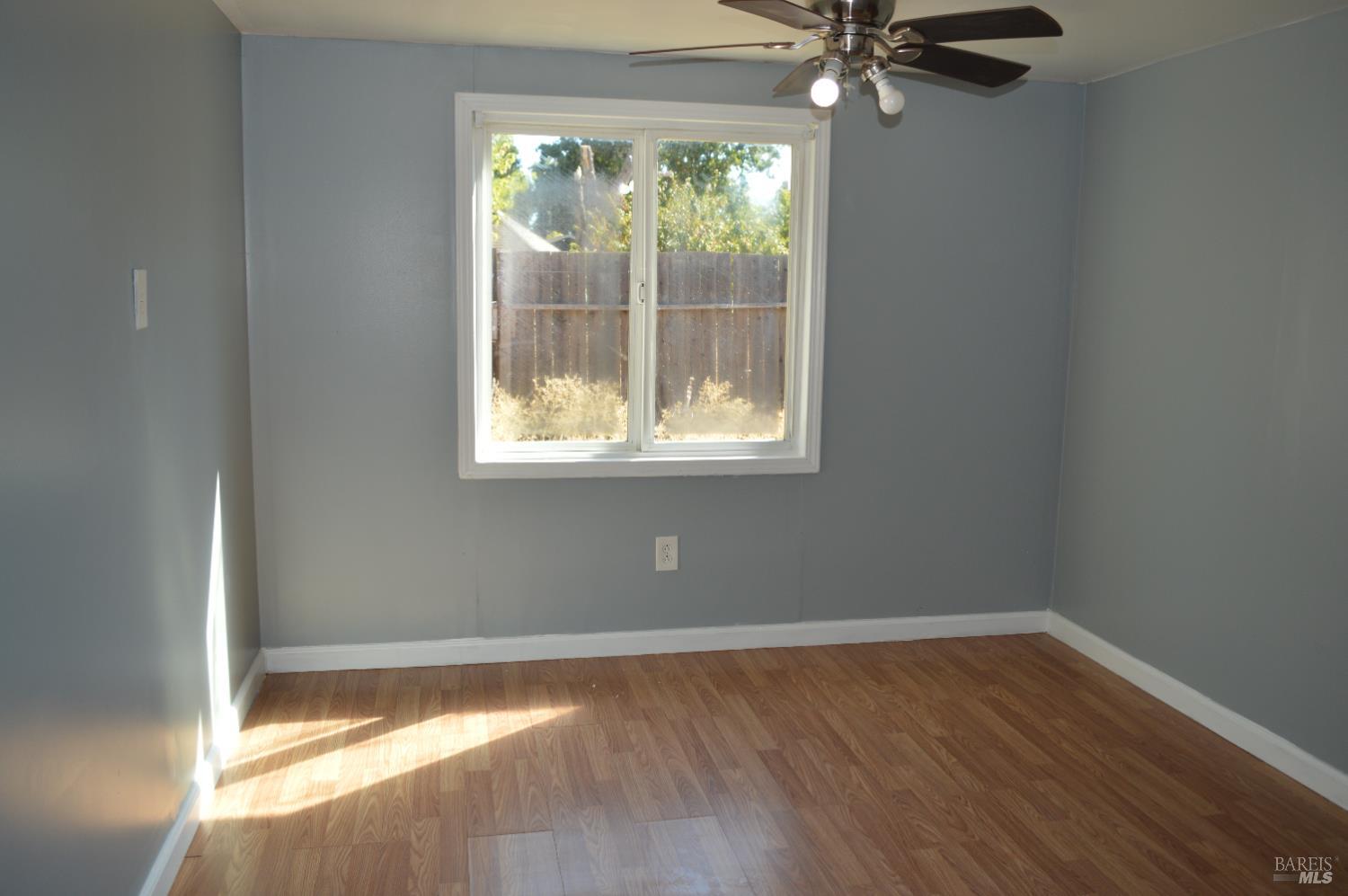 3525 Madrone Street Clearlake, CA 95422 - Photo 9 of 13 a view of an empty room with wooden floor and a window