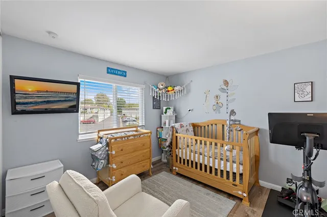 a bedroom with baby crib and a window