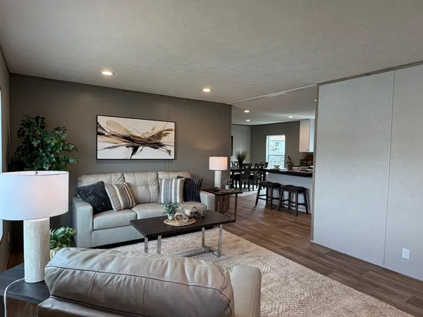 a living room with furniture and a potted plant