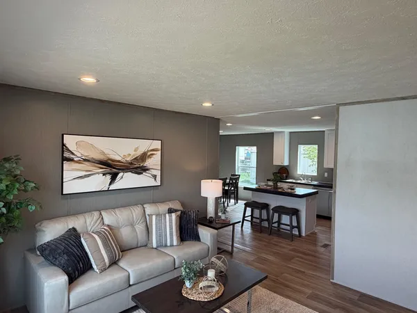 a living room with furniture a rug and a table