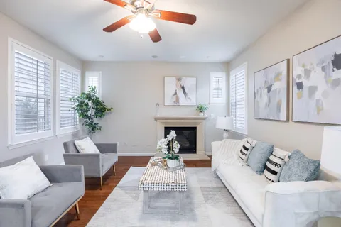 a living room with furniture and a fireplace