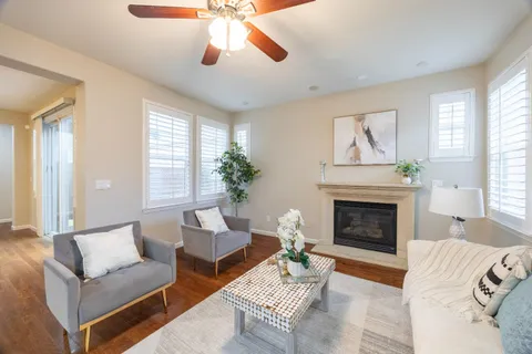 a living room with furniture kitchen view and a refrigerator
