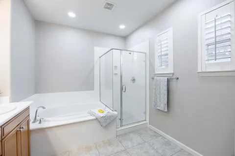a spacious bathroom with a double vanity sink mirror and double