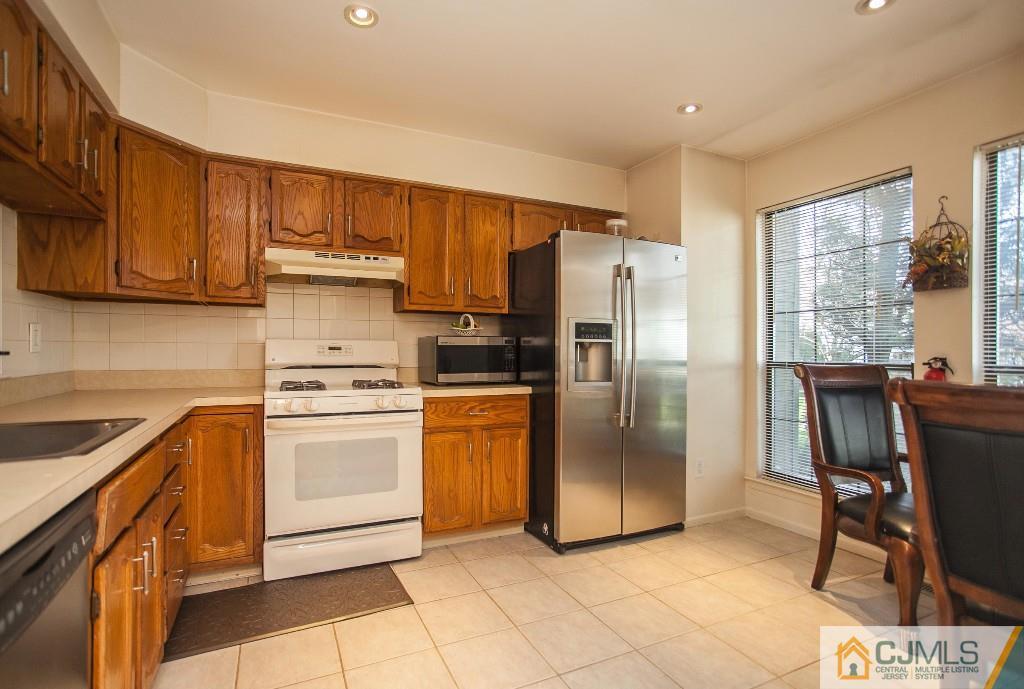1006 Timber Oaks Road Edison, NJ 08820 - Photo 2 of 13 a kitchen with stainless steel appliances granite countertop a refrigerator stove top oven and sink