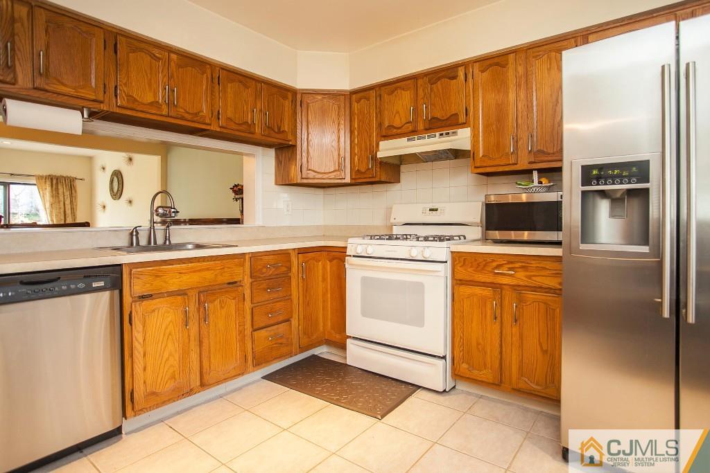 1006 Timber Oaks Road Edison, NJ 08820 - Photo 3 of 13 a kitchen with stainless steel appliances granite countertop a refrigerator sink and cabinets