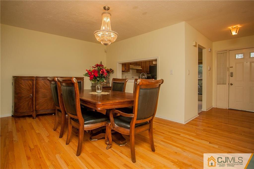 1006 Timber Oaks Road Edison, NJ 08820 - Photo 4 of 13 a view of a dining room with furniture and wooden floor