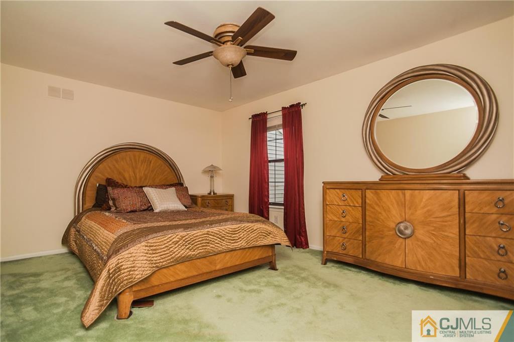 1006 Timber Oaks Road Edison, NJ 08820 - Photo 9 of 13 a bedroom with a bed a dresser and a window