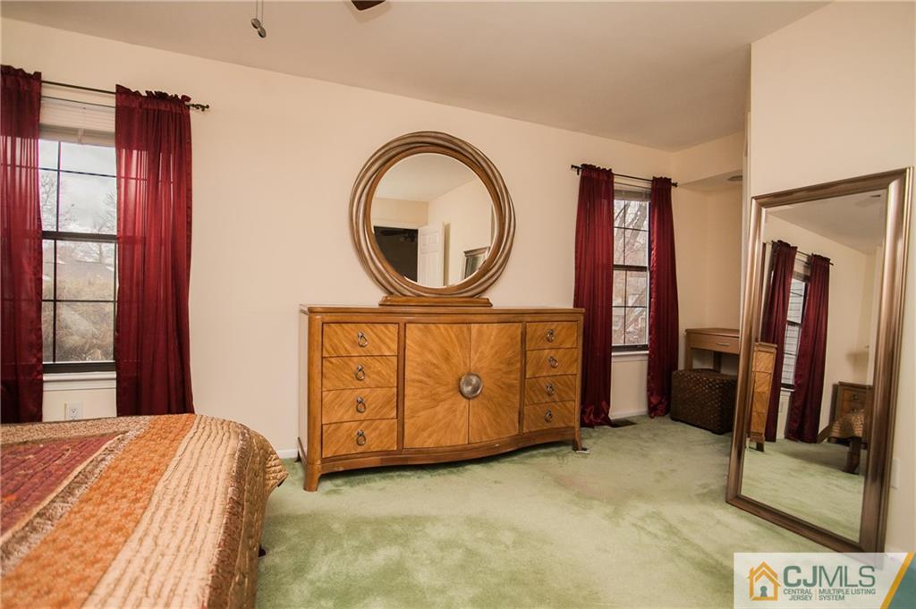 1006 Timber Oaks Road Edison, NJ 08820 - Photo 10 of 13 a bedroom with a bed and a mirror