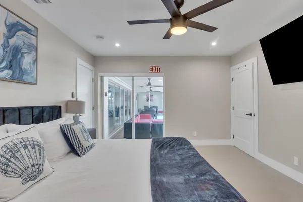 a bedroom with a bed and a flat screen tv