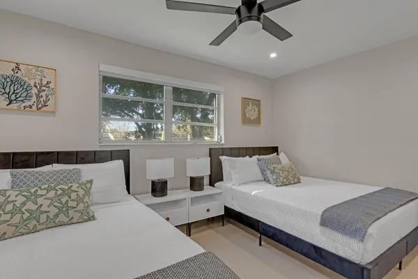 a bedroom with a bed and a ceiling fan