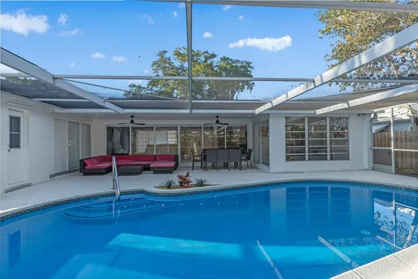 a view of a swimming pool with sitting area